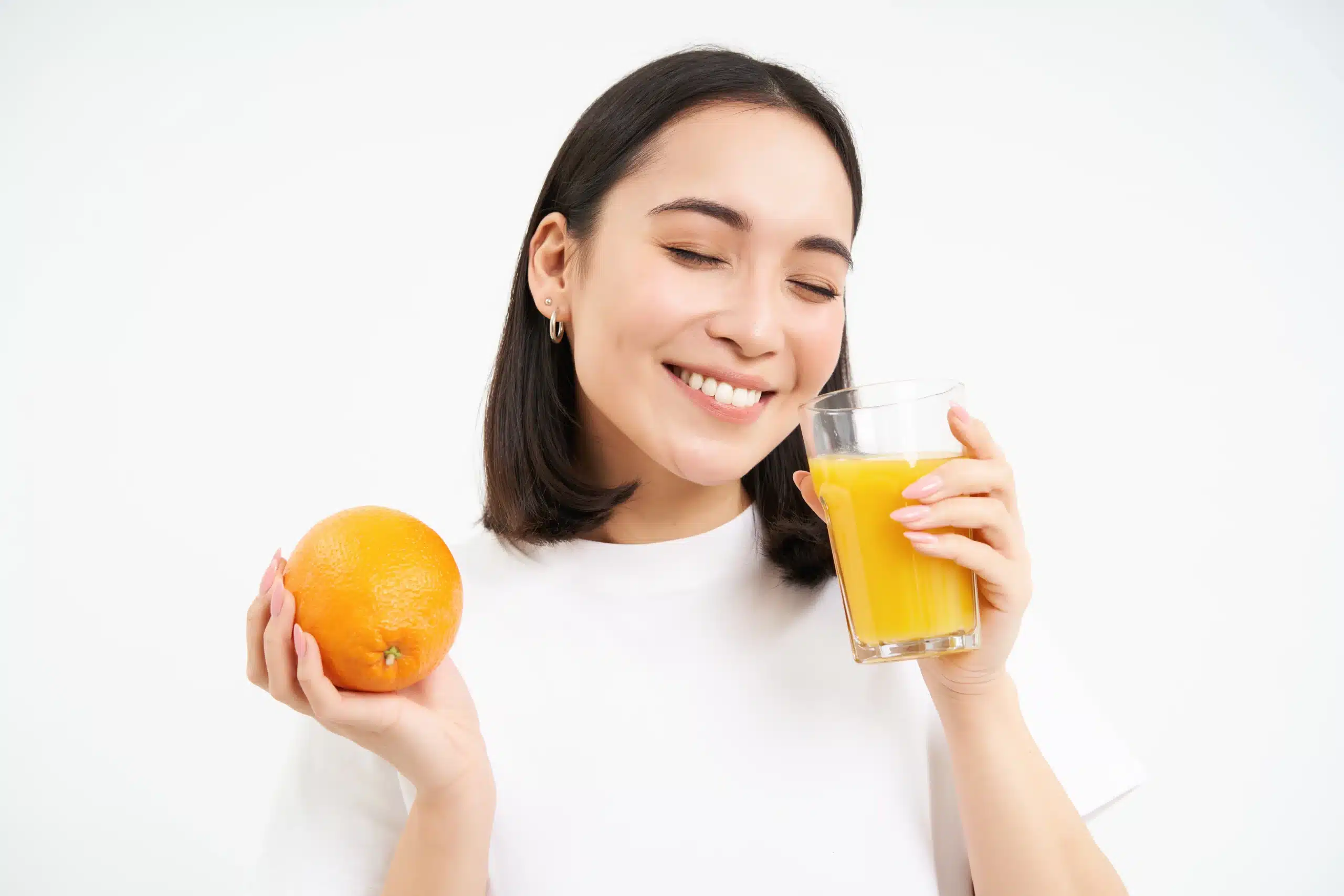 Woman with orange juice, the vitamin C boost of an Immune Boost vitamin drip in Bali